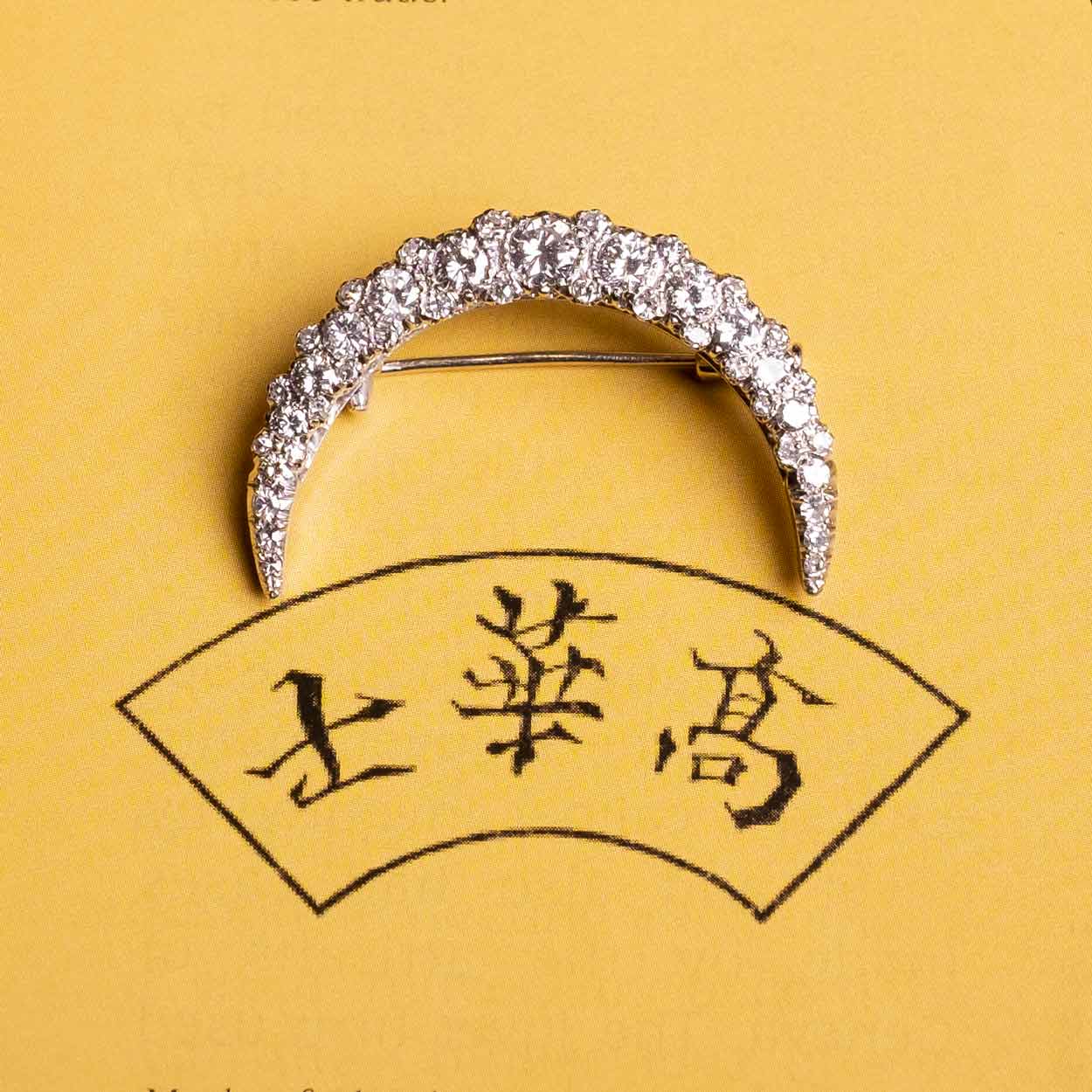 Crescent moon brooch with diamonds